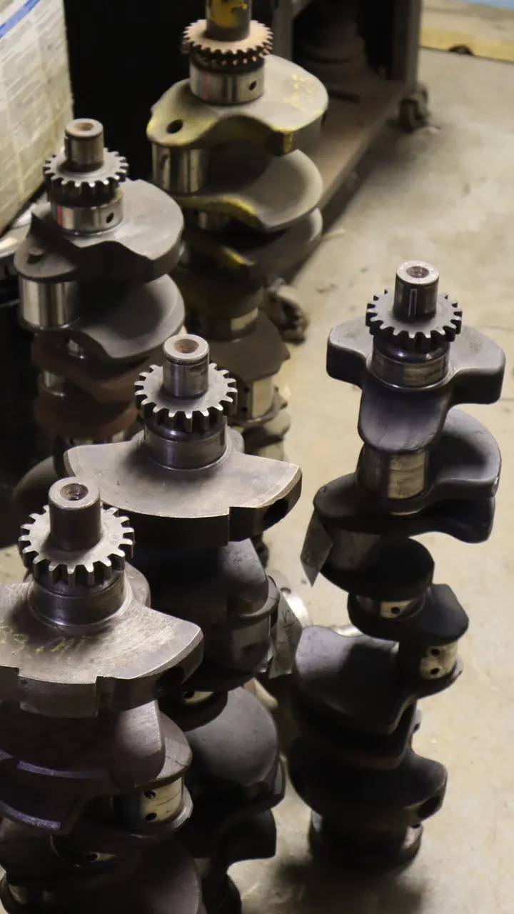 Several crankshafts and camshafts standing on end