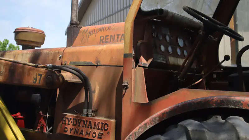 Close-up of the Dynahoe’s weathered orange seat and controls