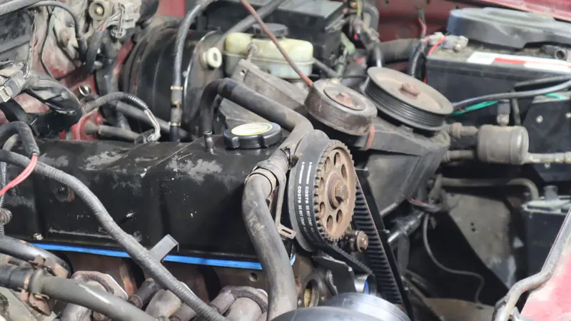 A V8 engine bay with the belts and pulleys exposed