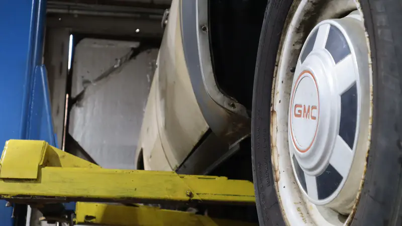 A GMC wheel and fender on the lift arms