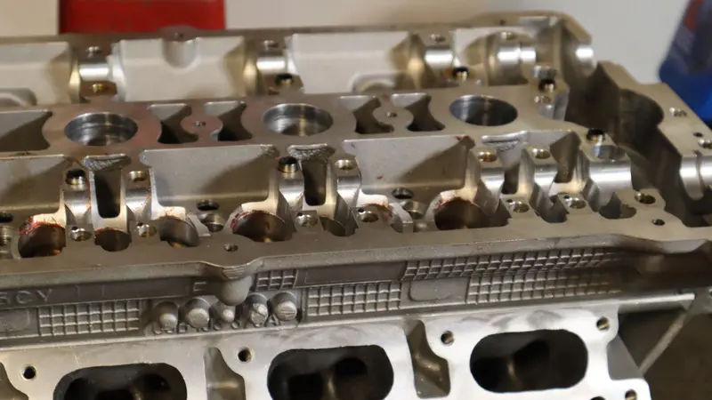 Close-up of a reconditioned aluminum cylinder head, valve seats exposed