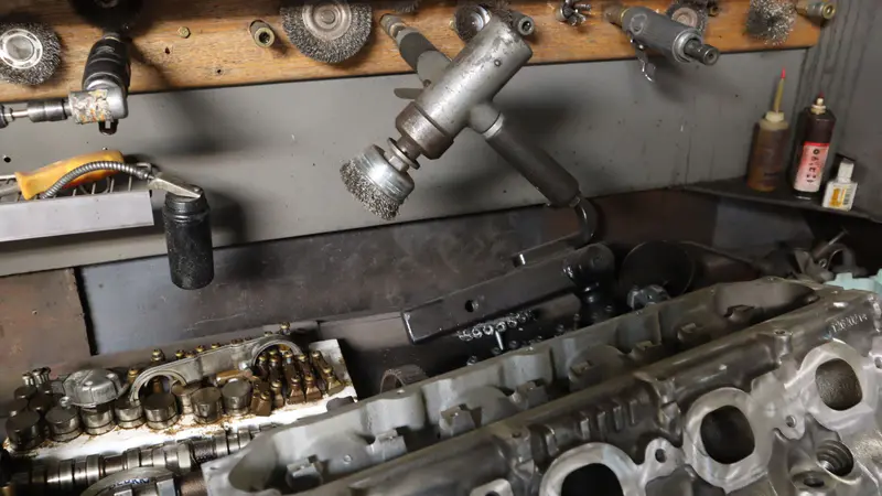 Cylinder heads and camshafts under the air tools at the head bench