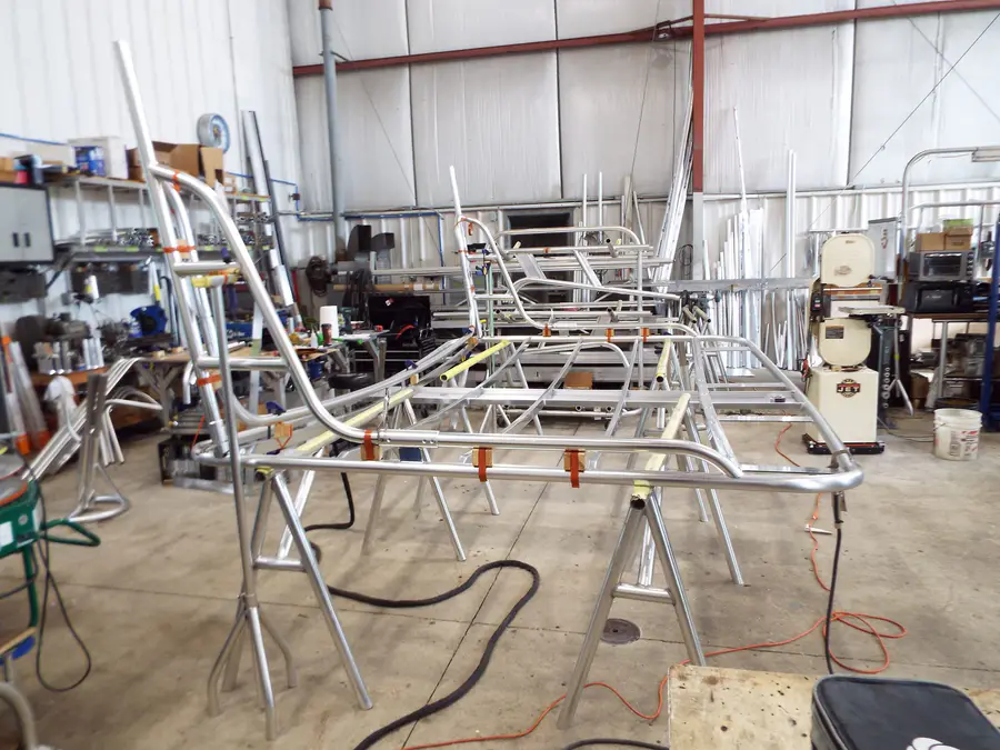 Aluminum rack frames going together on stands in the fab shop