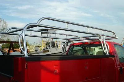 A polished aluminum ladder rack on a red work truck