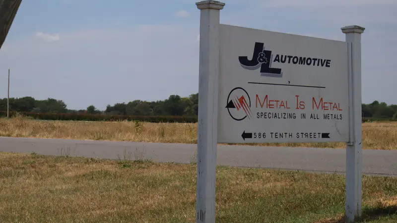 The J&L Automotive and Metal Is Metal road sign on Tenth Street