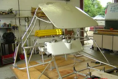 A low bridge T-top frame on stands in the shop, in for repair